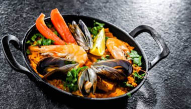 Seafood paella served in a cast iron pan.