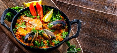 Seafood paella served in a cast iron pan.