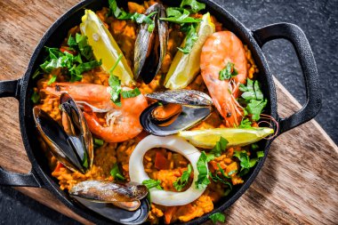 Seafood paella served in a cast iron pan.