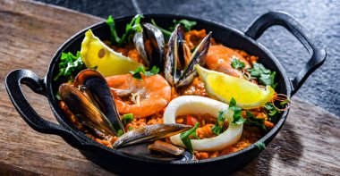 Seafood paella served in a cast iron pan.