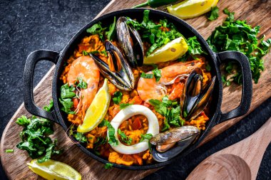 Seafood paella served in a cast iron pan.
