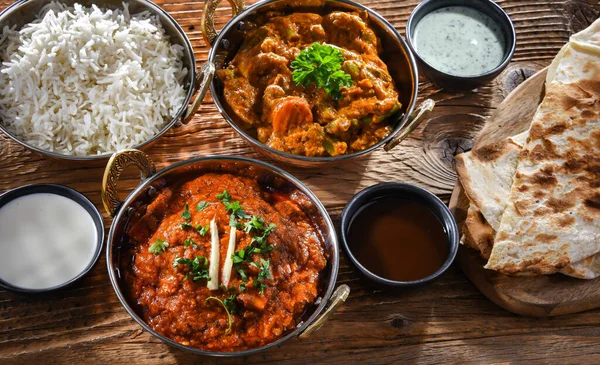 Hot madras paneer and vegetable masala with basmati rice served in original indian karahi pots.