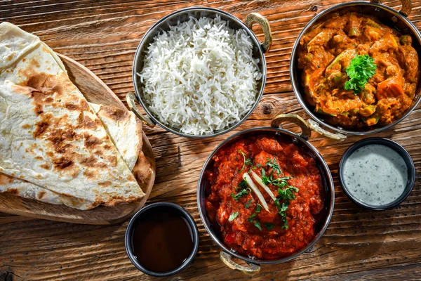 Hot madras paneer and vegetable masala with basmati rice served in original indian karahi pots.