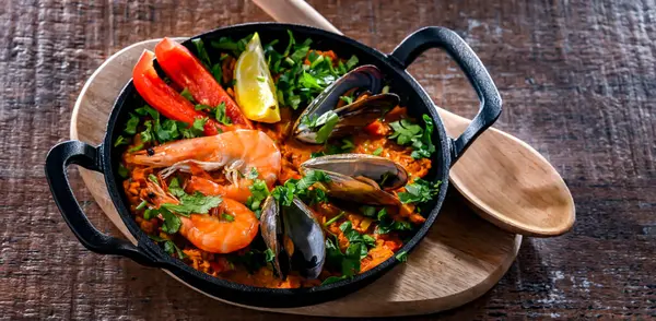 Seafood paella served in a cast iron pan.