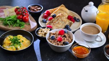 Breakfast served with coffee, orange juice, scrambled eggs, cereals, pancakes and croissants.