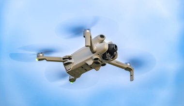 POZNAN, POL - APR 29, 2024: Drone DJI Mini 4 PRO during flight clipart