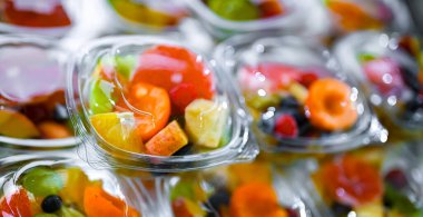 Plastic boxes with pre-packaged fruit salads, put up for sale in a commercial refrigerator