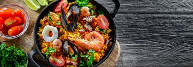 Seafood paella served in a cast iron pan.