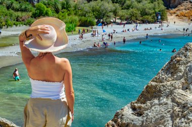 A tourist looking at Preveli beach, Crete, Greece clipart