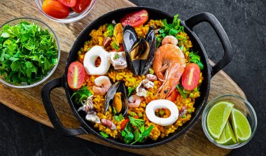 Seafood paella served in a cast iron pan.