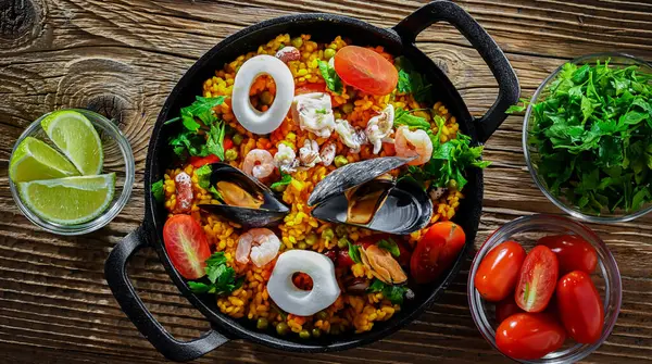 Seafood paella served in a cast iron pan.