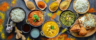 Hint yemekleri ile kompozisyon: medras paneer, palak paneer ve shahi paneer ile orijinal Hint karahi kaplarında servis edilen basmati pilavı