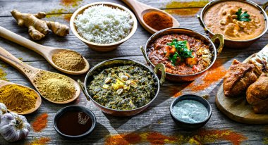 Hint yemekleri ile kompozisyon: medras paneer, palak paneer ve shahi paneer ile orijinal Hint karahi kaplarında servis edilen basmati pilavı