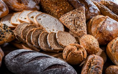 Assorted bakery products including loaves of bread and rolls