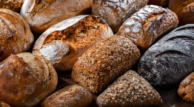 Assorted bakery products including loaves of bread and rolls