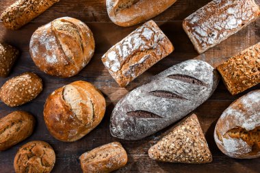 Assorted bakery products including loaves of bread and rolls