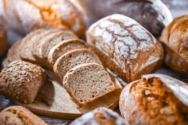 Assorted bakery products including loaves of bread and rolls