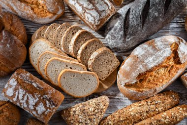 Assorted bakery products including loaves of bread and rolls