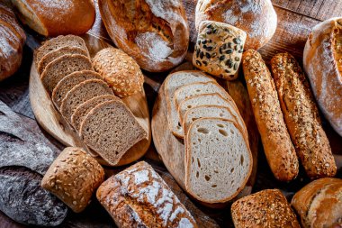 Assorted bakery products including loaves of bread and rolls