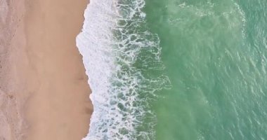 Aerial drone flight over the sea line breaks waves on the sandy beaches in Areyns de Mar Spain