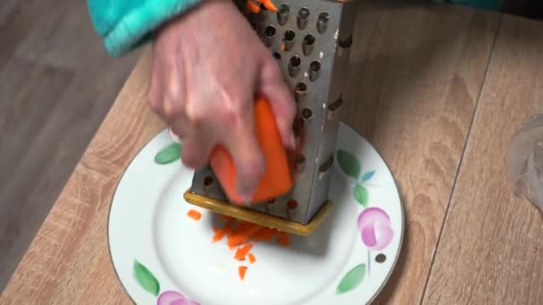 Woman Grinds Carrot Grater — Stock Video