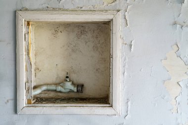 Broken of the old fire hose cabinet on the wall.