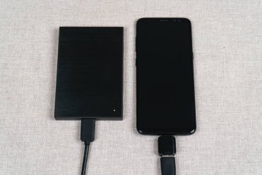 External hard drive is connected to the smartphone.