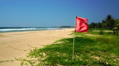 Red flag waving at the beach.