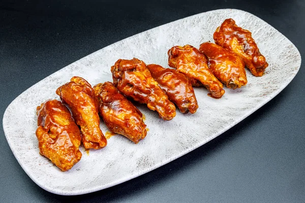 Composition Plate Chicken Wings Barbecue Sauce Black Background Stock Picture