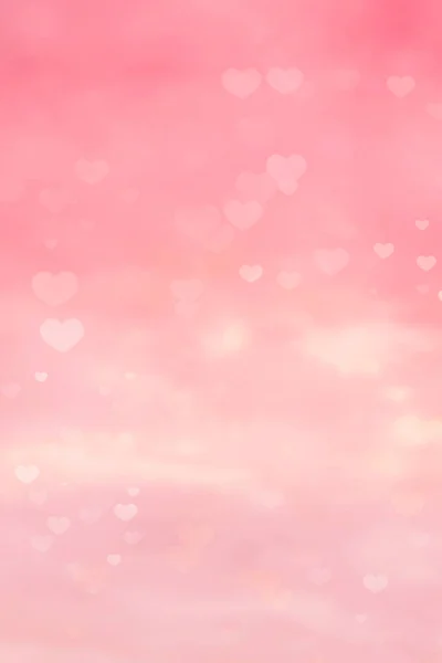 要旨ピンク色の空の背景とハート型のボケ — ストック写真