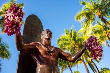 Honolulu, Hawaii - December 26, 2022: Duke Kahanamoku statue in front of Kuhio Beach Park in Waikiki was a Native Hawaiian competition swimmer who popularized the ancient Hawaiian sport of surfing