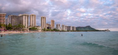 Honolulu, Hawaii - December 29, 2022: View of Waikiki Beach with Diamond Head valcano in the distance.
