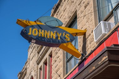 Fort MacLeod, Alberta - March 31, 2024: Vintage neon sign on Johnny's Restaurant in Fort MacLeod Alberta. clipart