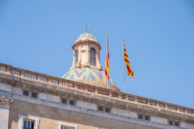 Flags on top of the Palau de la Generalitat, seat of the Catalan Government in Barcelona, Catalonia. clipart