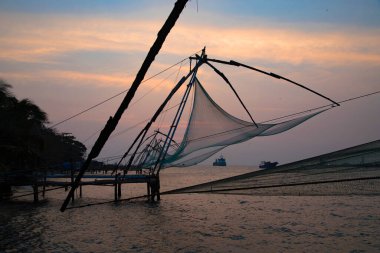 Koçin Kalesi Kochi, Kerala, Hindistan 'da gün doğumunda Çin balık ağı üzerinde gün batımı