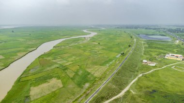  Sariagarh 'da koshi nehrinin yanındaki doğu koridoru karayolunun hava manzarası. Hindistan, Bihar' da kırsal alanda çalışan bir otobüs kamyonuyla otoyol manzarası..