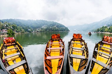 Nainital, uttarakhand, India. 21 june 2022. Colorful boats for tourists in the naini lake, nainital, uttarakhand, India. clipart