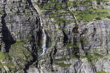 Beautiful himalayan mountain landscape in the evening with waterfall and chenab river at lahaul, gramphu-batal-kaza road himachal pradesh, India. clipart