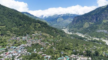 Aerial view of manali with the beas river in himachal pradesh India. Himalayan mountains and colourful local houses nestled in the hills of manali himachal pradesh India. clipart