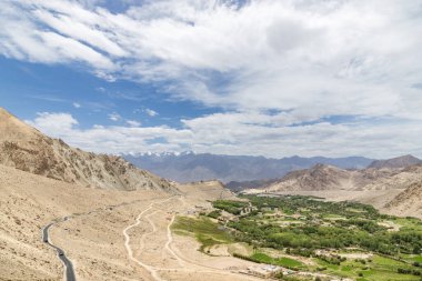 view of leh city surrounded by beautiful himalayan mountains, passing through the khardung la road in the ladakh district, India. clipart