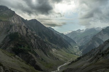 Beautiful Himalayan mountain landscape view of Baltal on Zoji La Pass with Sindh River in the Srinagar-Leh road in Jammu and Kashmir, India. clipart