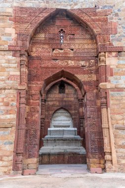 The Tomb of Sultan Shamsuddin Iltutmish in Delhis Qutub Minar Complex is part of a historic site featuring the worlds tallest brick minaret at 72.5 meters. clipart