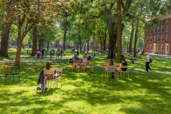 stock image CAMBRIDGE, MA, USA - SEPTEMBER 13, 2017: Students and tourists rest in lawn chairs in Harvard Yard, the open old heart of Harvard University campus  in Cambridge, MA, USA.