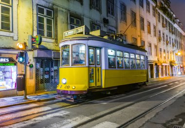 Lisbon, Portugal - December 28, 2008: Traditional yellow tram downtown Lisbon by night on December 29, 2008. Trams are used by everyone and also keep the traditional style of the historic center of Lisbon.