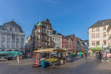 Trier, Germany - November 7, 2020: people go shopping at the central market square in Trier at the farmers market.