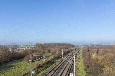 rails with electrification for highspeed train in Germany under blue sky