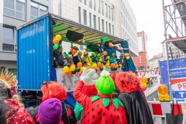 Osnabrueck, Germany - February 19, 2023: people celebrate the carnival parade in Osnabrueck on a rainy day.