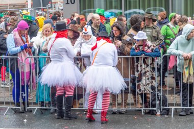 Osnabrueck, Germany - February 19, 2023: people celebrate the carnival parade in Osnabrueck on a rainy day.