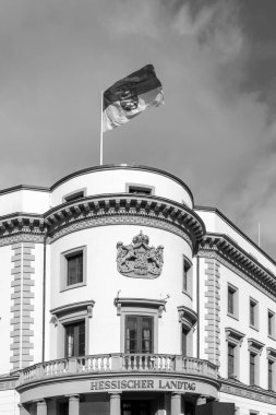 view to parliament of Hesse in Wiesbaden, a former castle, with Hesse Flag at roof top under blue sky