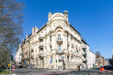 Wiesbaden, Germany - March 2, 2023: people at Kaiser Friedrich Ring - engl: King Friedrich circle - with its old scenic facade of the 19th century in classicistic and Art Nouveau style.